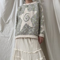 a woman wearing a sweater with a star pattern