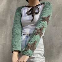 a woman wearing a sweater with stars on it